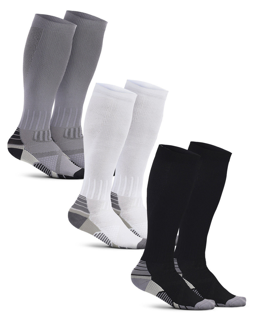 Set of gray, white, and black knee-high socks on a white background