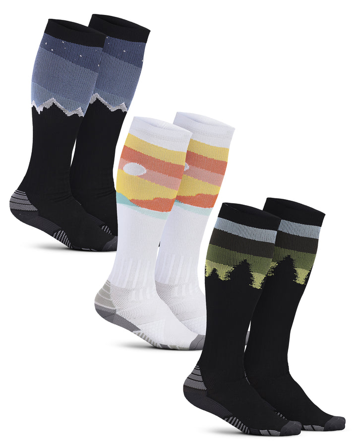 Set of four pairs of socks with different designs on a white background