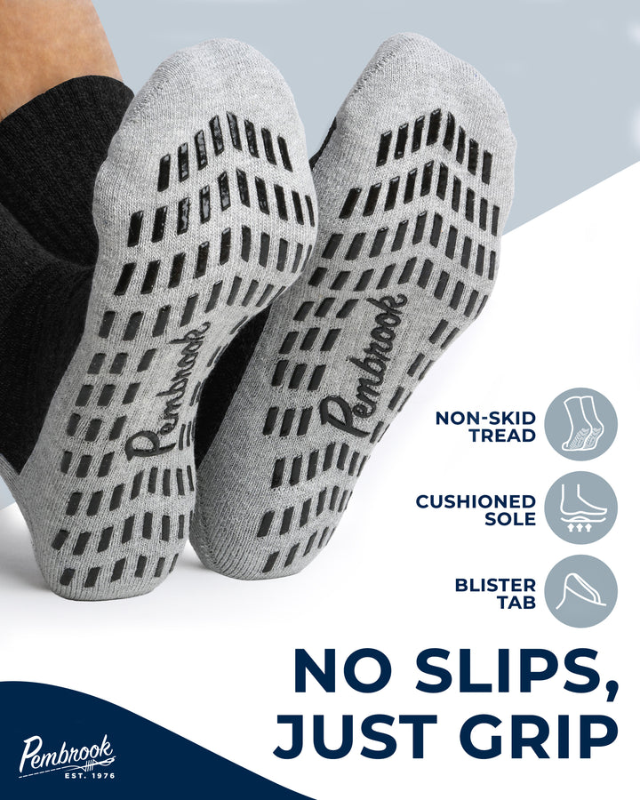 Gray grip socks with text highlighting features on a light gray background