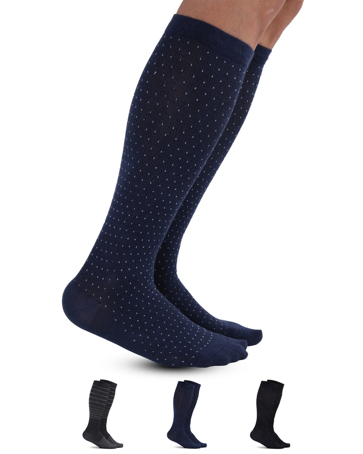 Navy knee-high socks with white polka dots on a white background