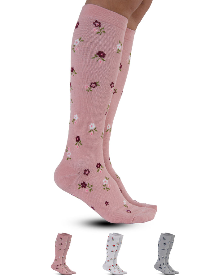Pink knee-high socks with floral pattern on a white background