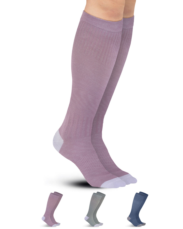 Purple knee-high socks with additional pairs in the background on a white background