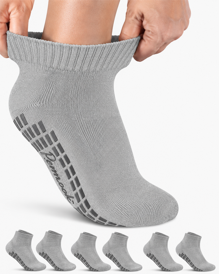Gray ankle sock with textured sole held up, with six additional socks displayed below on a white background.