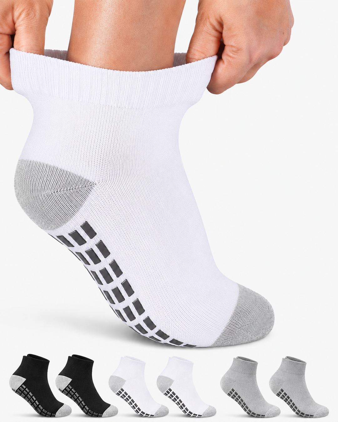 White ankle sock with black pattern on sole, held up by a person, with additional socks displayed below.