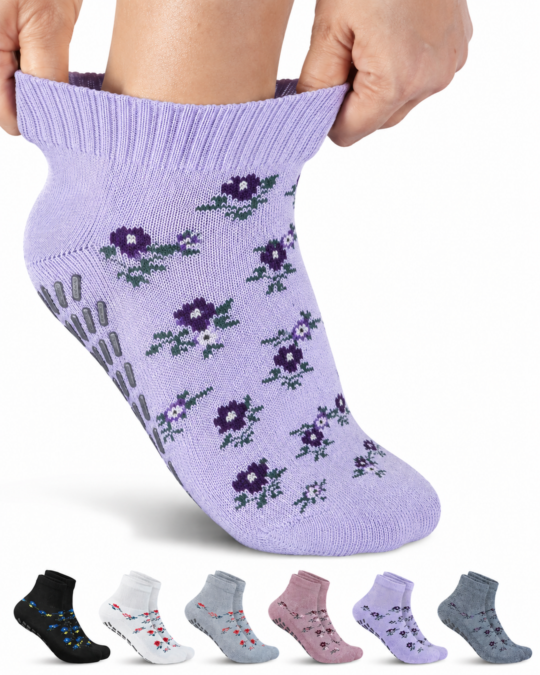 Purple socks with floral patterns held up against a white background
