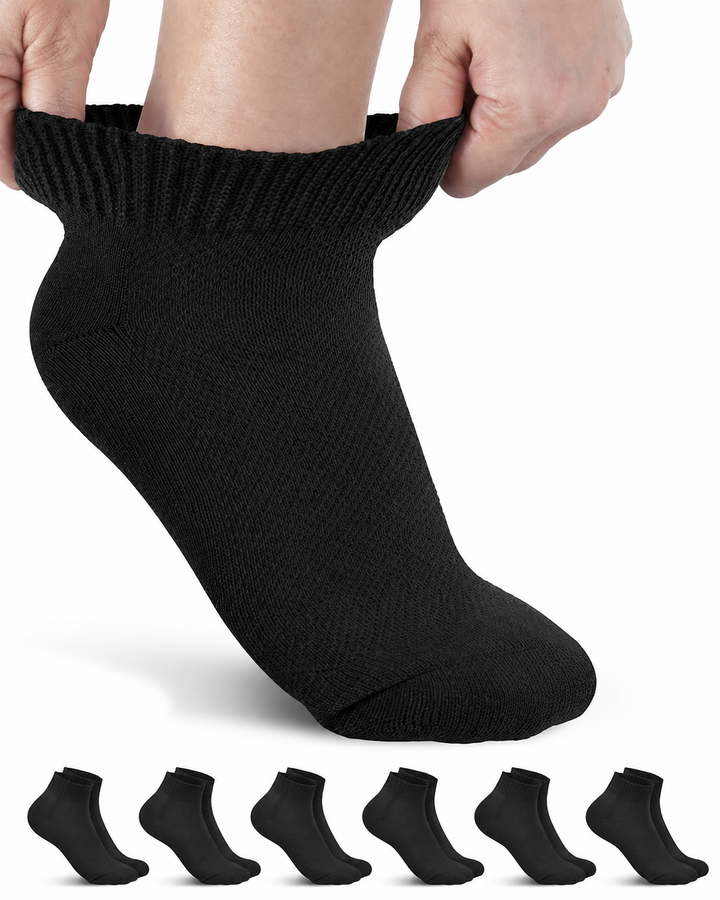 Person wearing a black ankle sock with six additional black socks displayed below on a white background