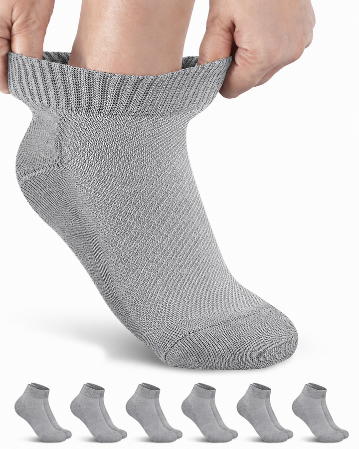Person wearing a gray ankle sock with six additional socks displayed below on a white background