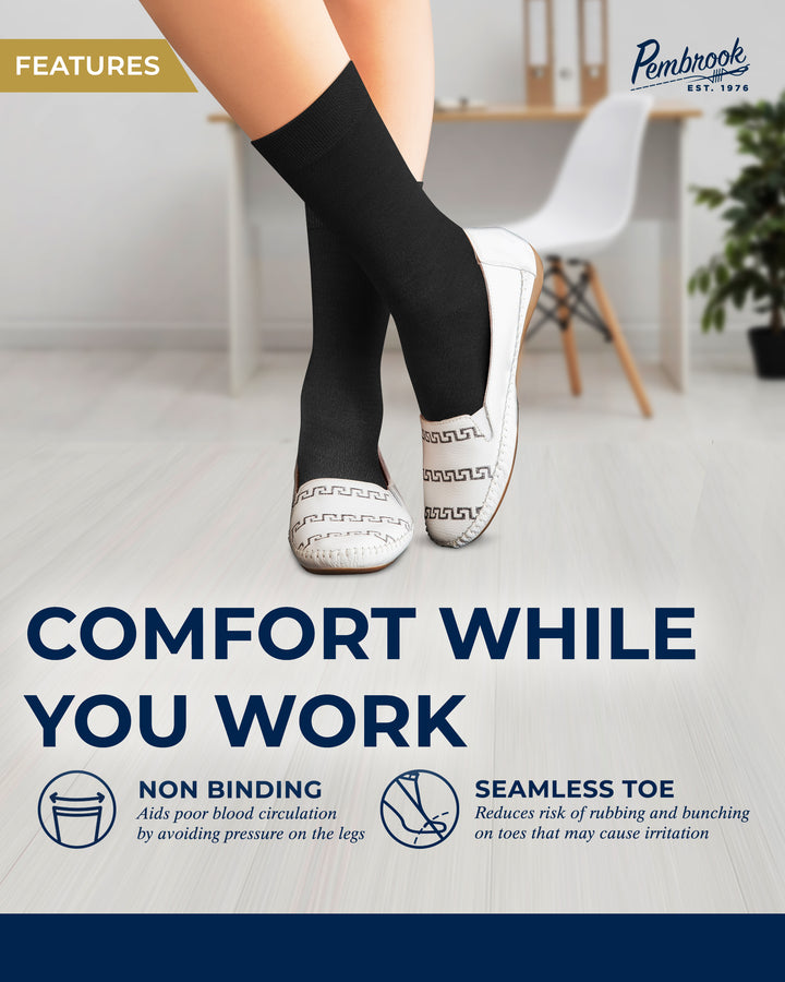 Person wearing black compression socks with text about comfort while working, set against a blurred office background.