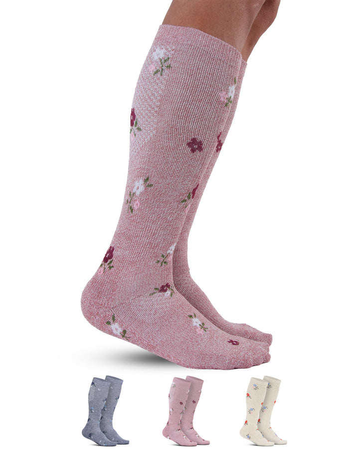 Pink knee-high socks with floral pattern on a white background