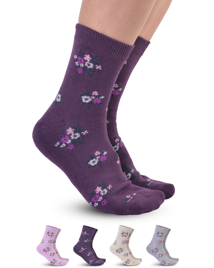 Purple socks with floral patterns worn by a person on a white background