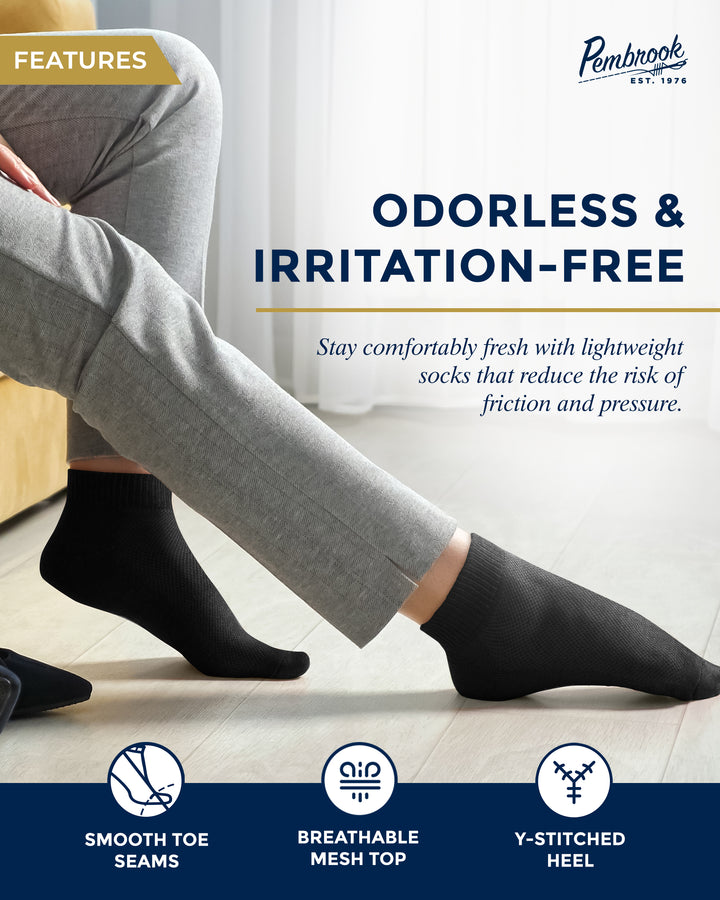 Person wearing black socks with text highlighting odorless and irritation-free properties, brand &