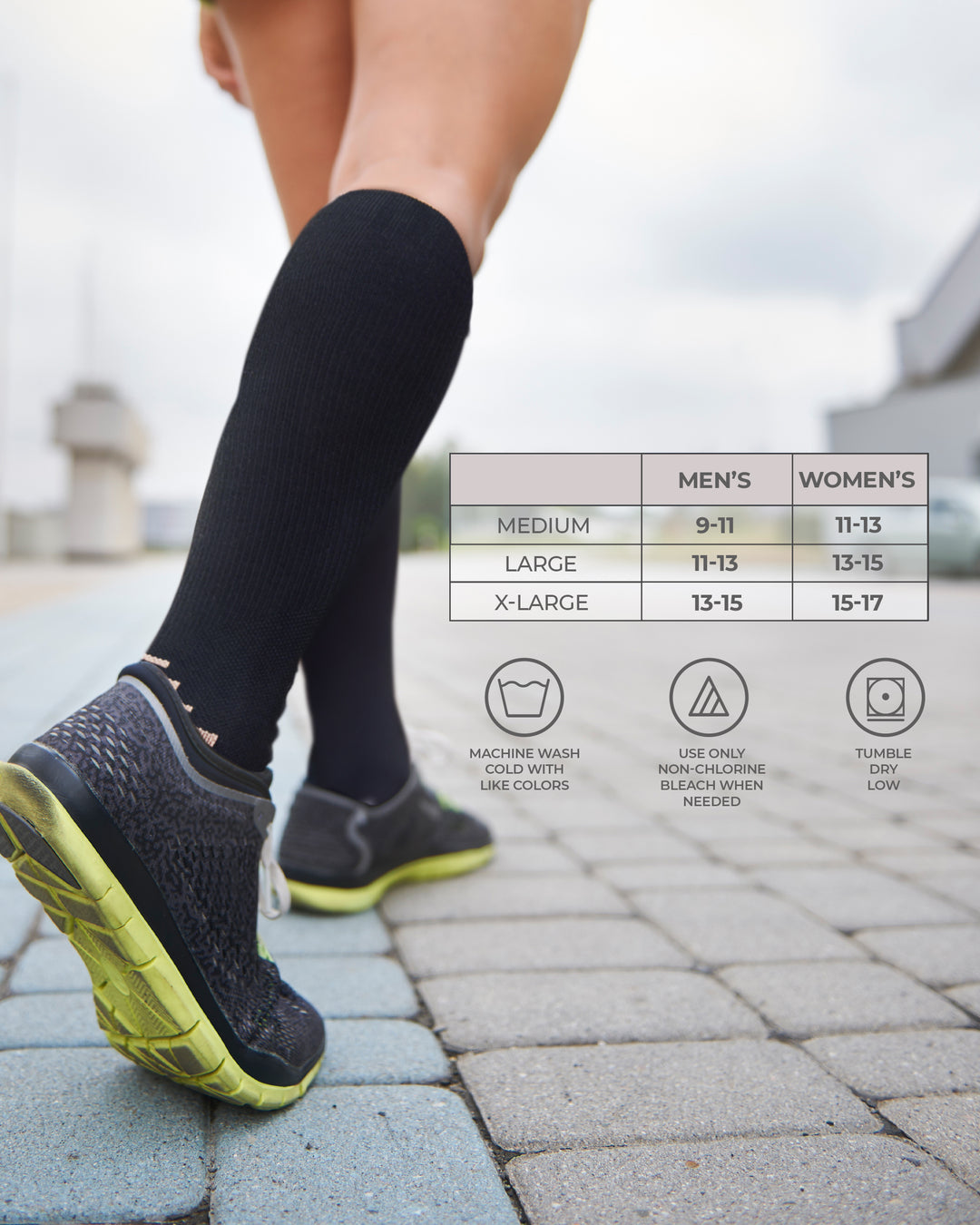 Person wearing black compression socks with running shoes on a paved path, featuring size chart and care instructions.